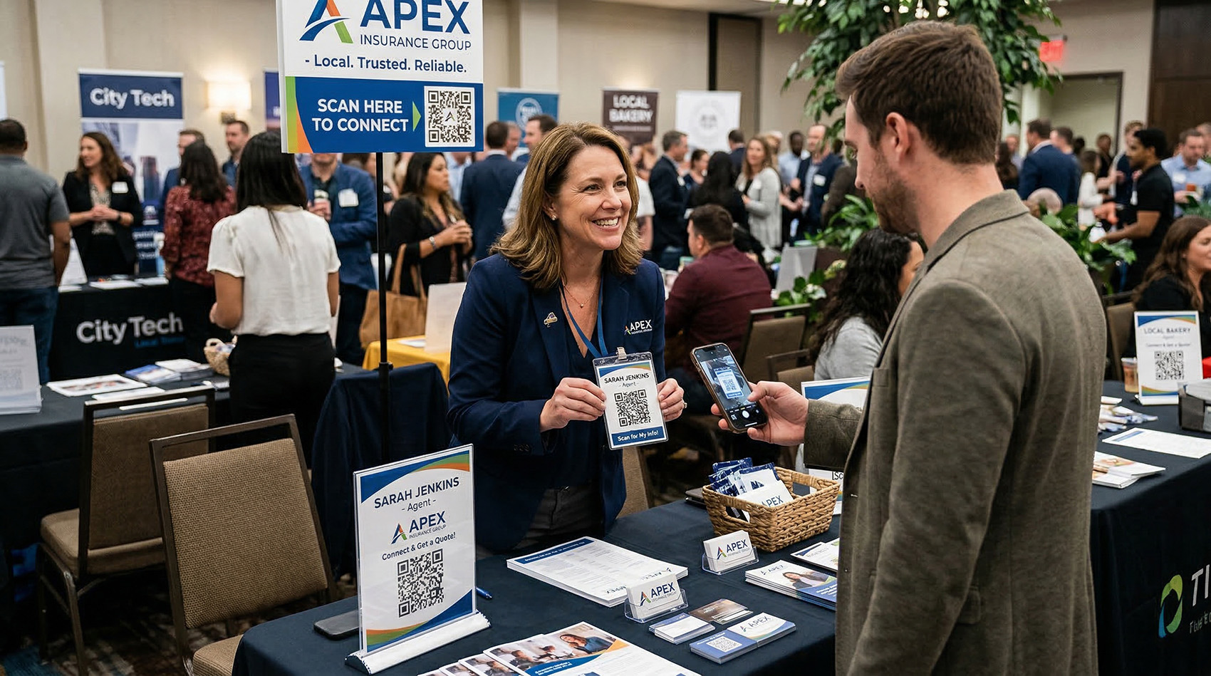 Insurance agent at a networking event showing a QR code while someone scans it with their phone